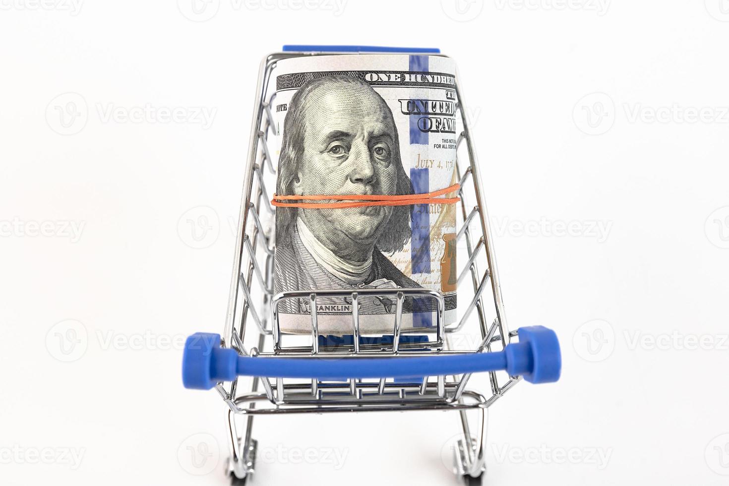 Shopping basket and US dollars on a white background. Copy space. photo