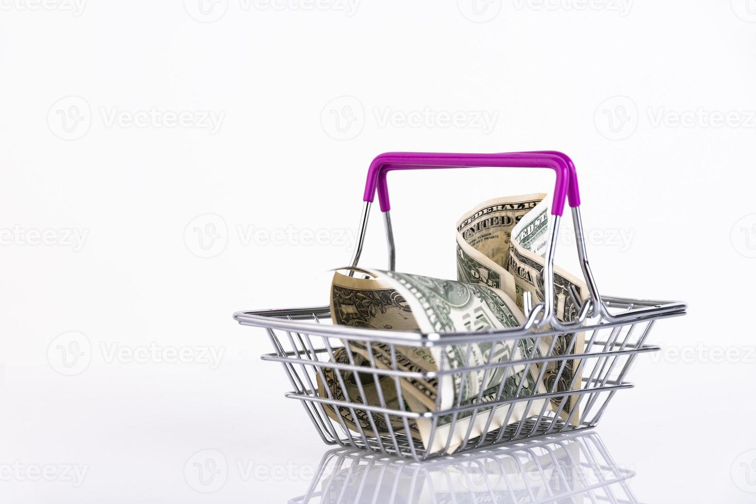 Shopping basket and US dollars on a white background. Copy space. photo