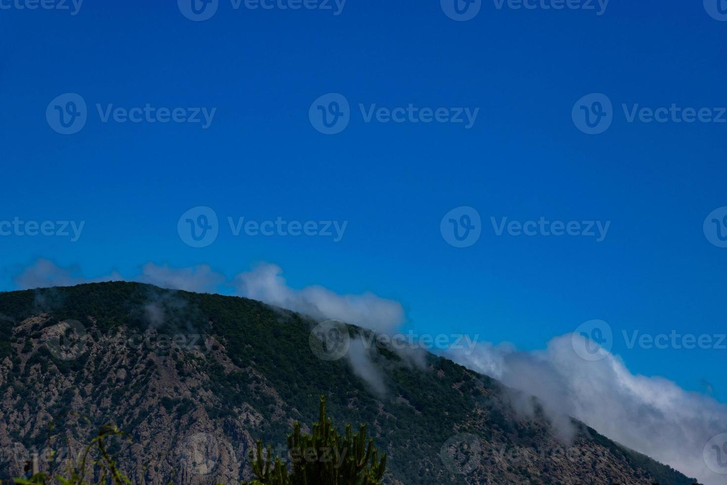 Mount Ayu Dag with clouds on the background of the Black Sea in the early morning. photo