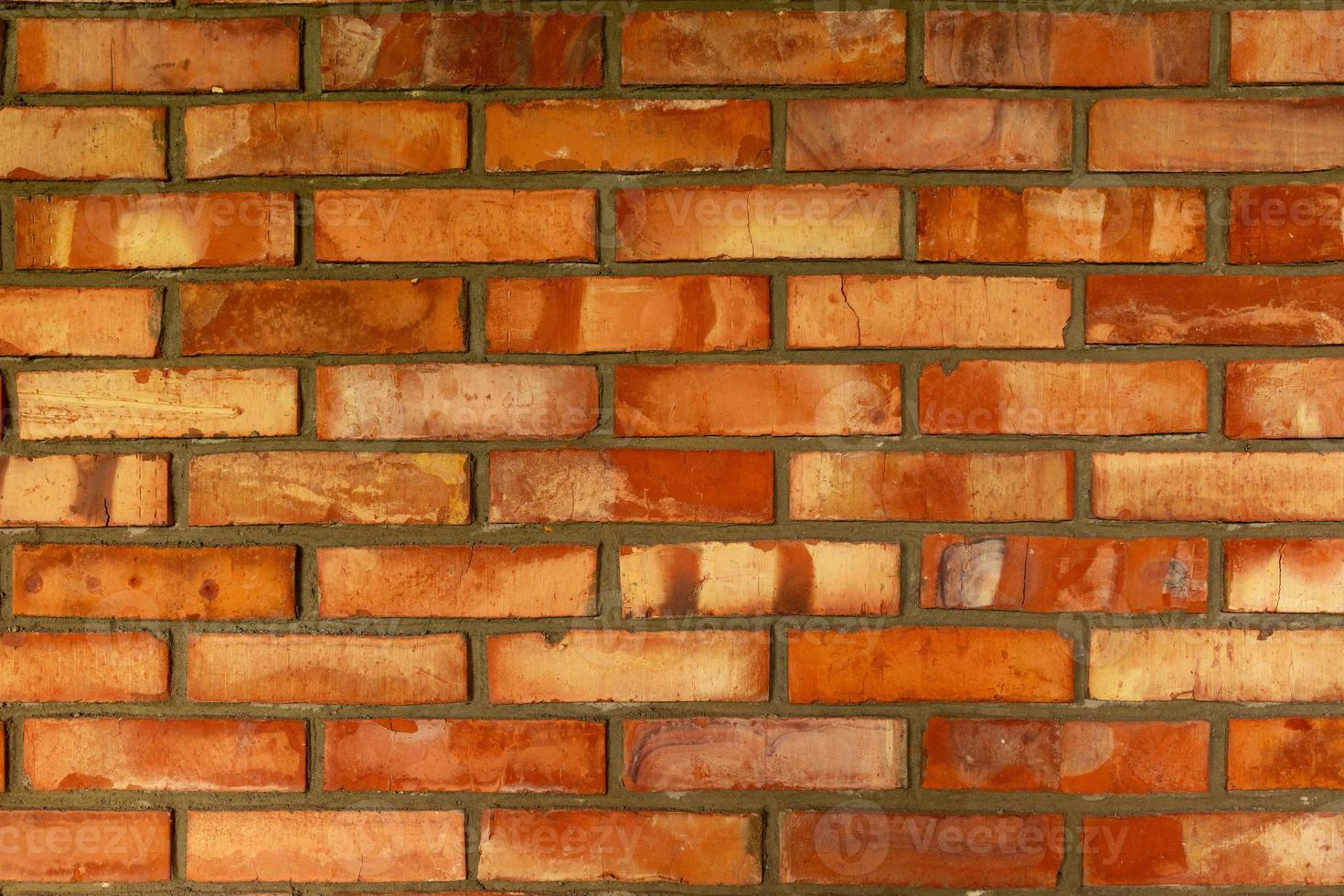 New brick wall from red bricks close-up texture. photo