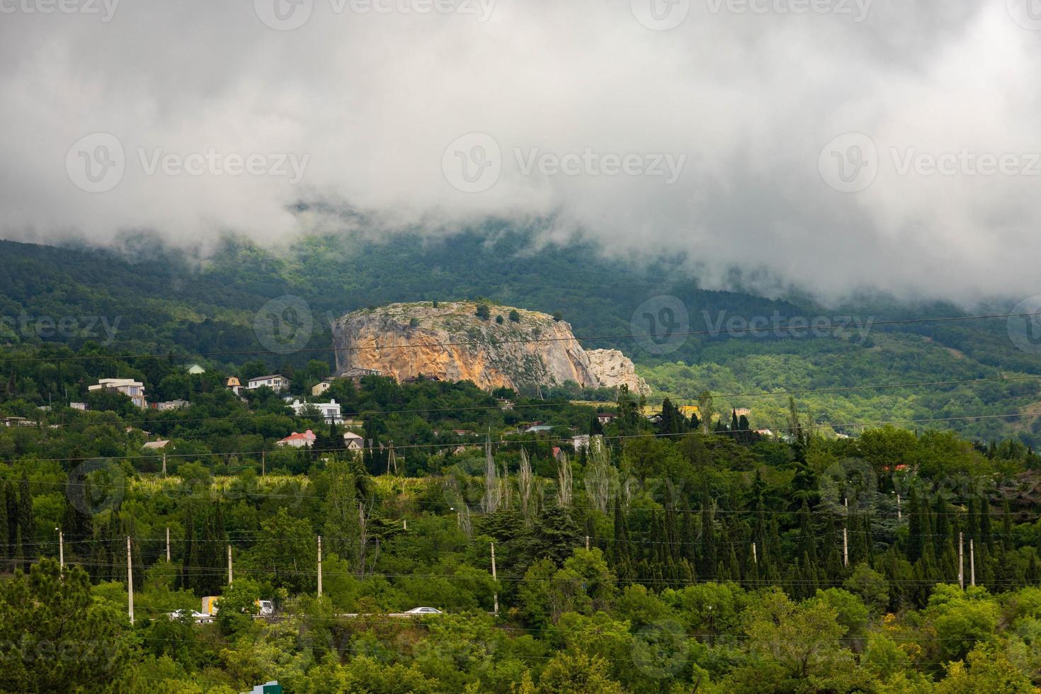 Red rock, cliff in the Gurzuf valley on the southern coast of the Crimea peninsula, located at an altitude of 430 meters above sea level. photo