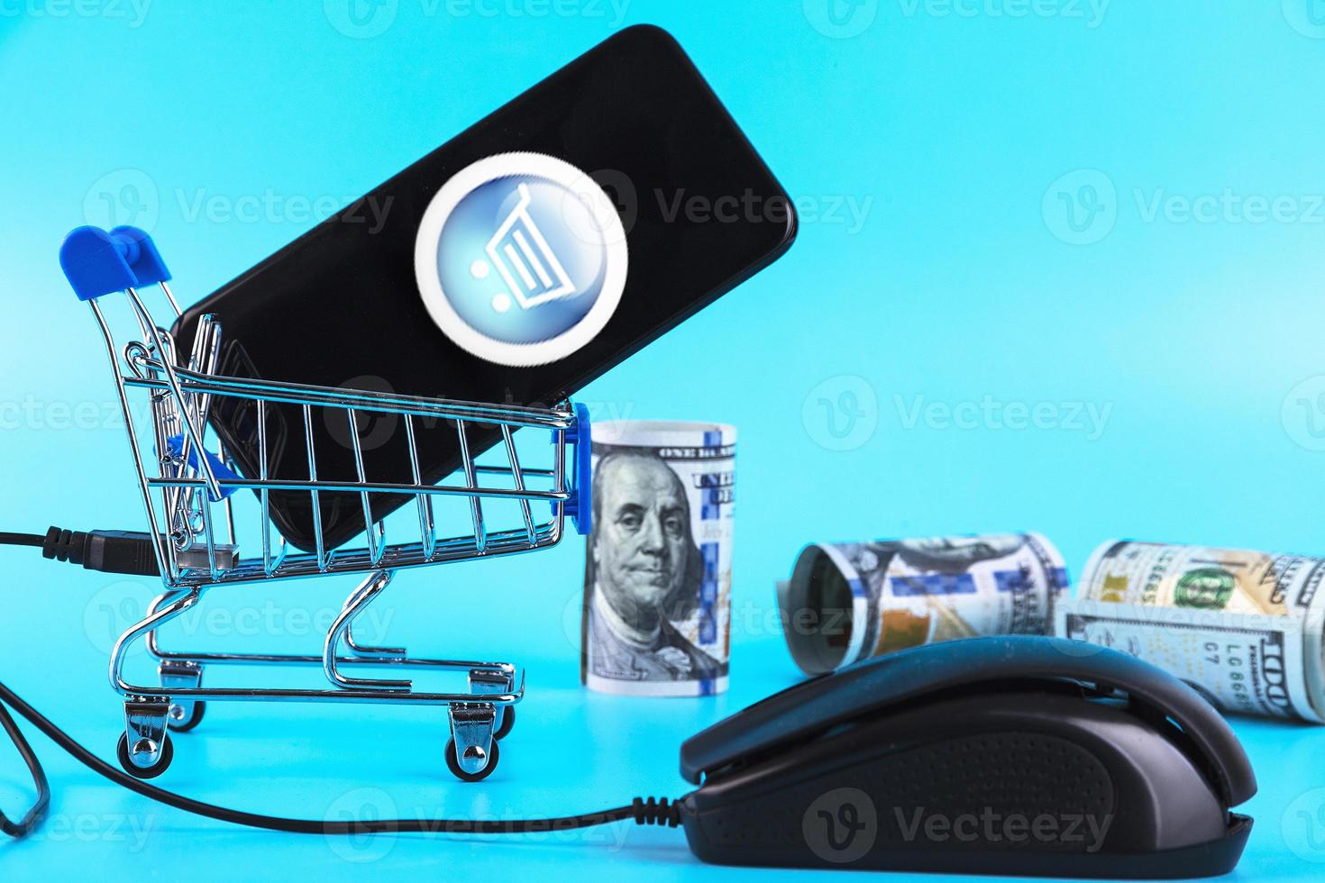 Shopping cart and computer mouse, roll one hundred dollar bills online shopping concept. Copy space. photo