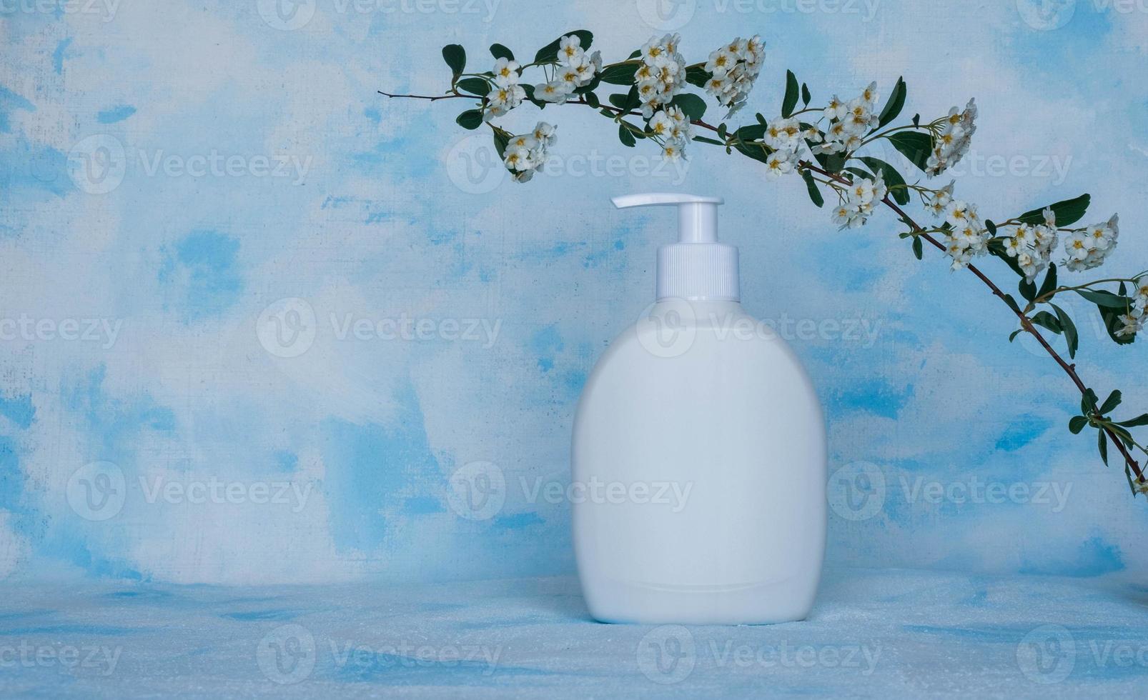 Pure white, plastic, container. Packaging, bottle template for cosmetics, cream, hair mask, for medical and beauty products. anvas Light background with a flowering branch on top photo