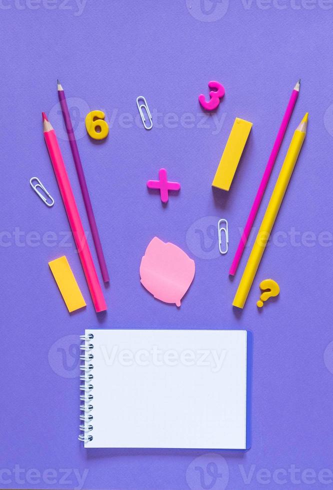 Back to school concept. School and office supplies on the office table. Violet background.Flat lay photo