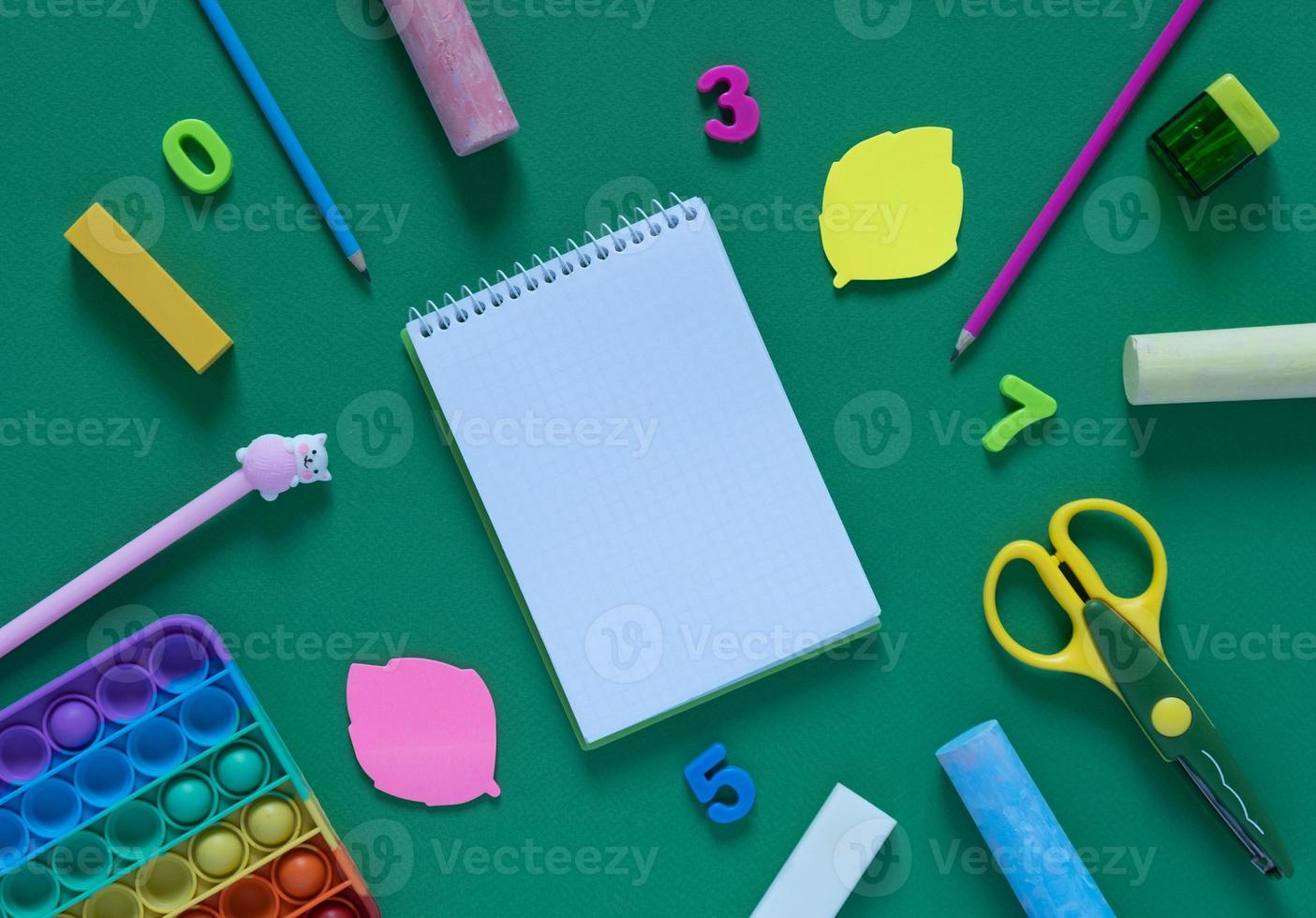 Back to school concept. School and office supplies on the office table and antistress toy. Flat lay photo