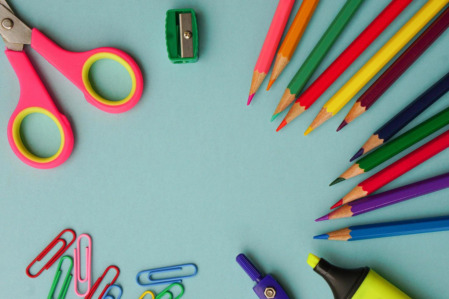 Top view of school supplies and office supplies on blue background. Learning, study, office equipment and presentation concept. photo