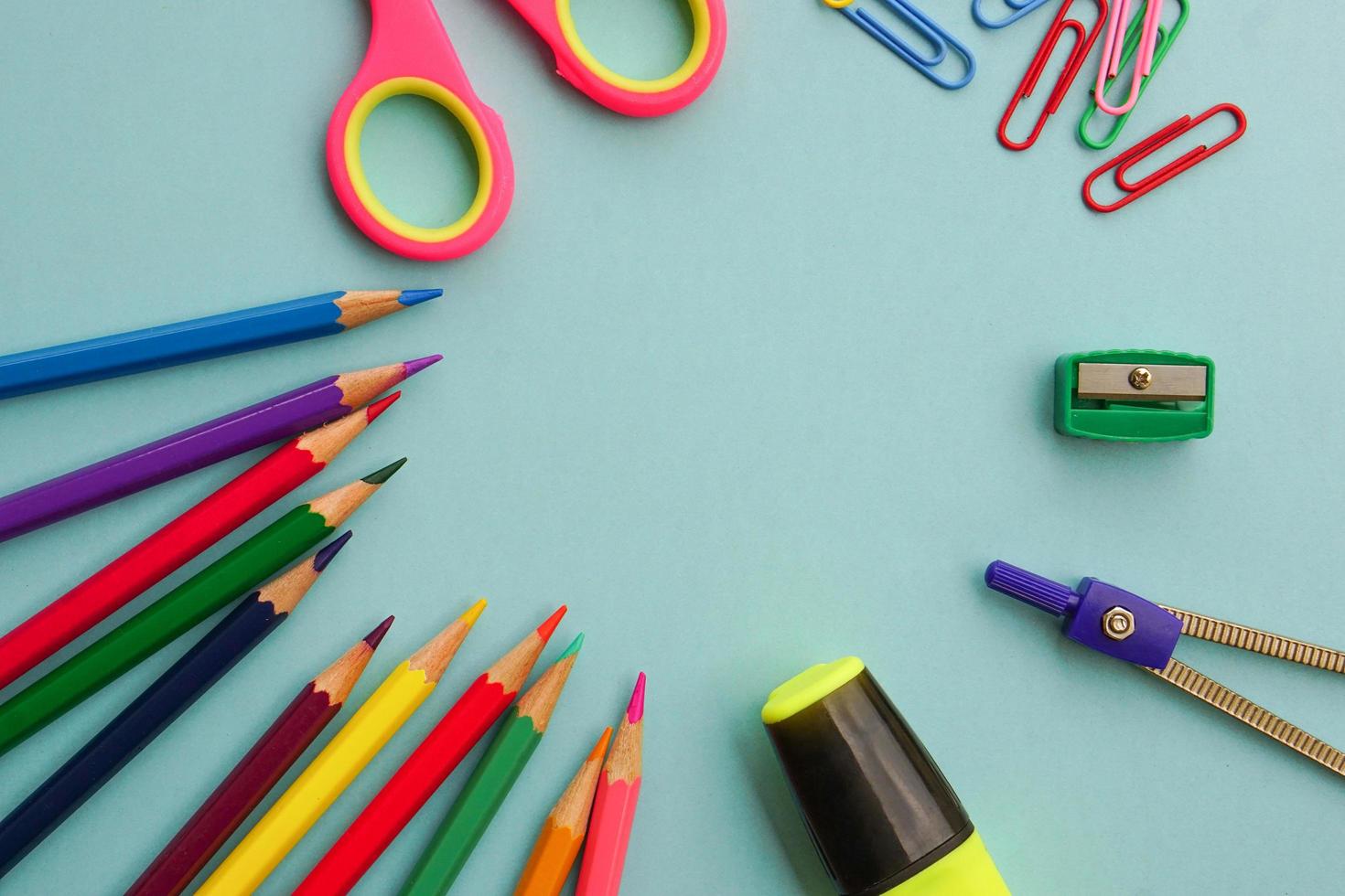 Top view of school supplies and office supplies on blue background. Learning, study, office equipment and presentation concept. photo
