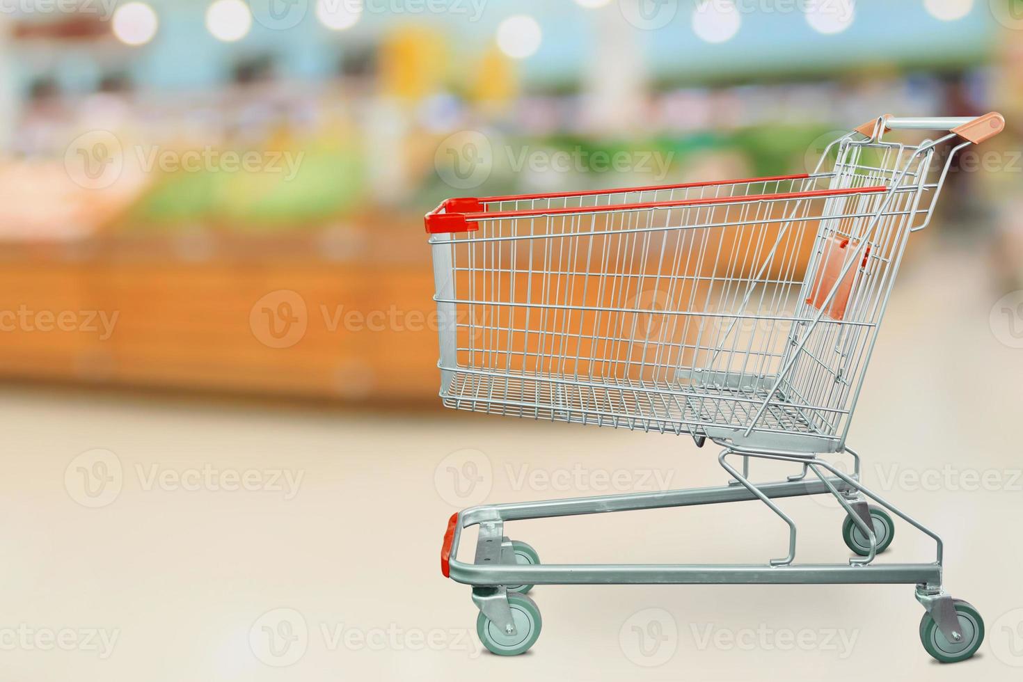 Supermarket grocery store with empty shopping cart photo