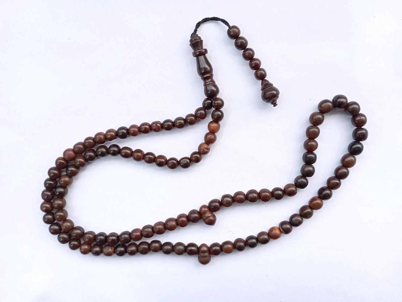 prayer beads or rosaries isolated on a white background photo