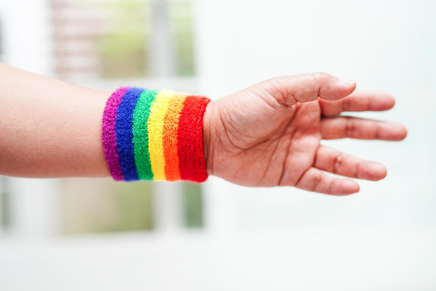 Asian woman with rainbow flag, LGBT symbol rights and gender equality, LGBT Pride Month in June. photo