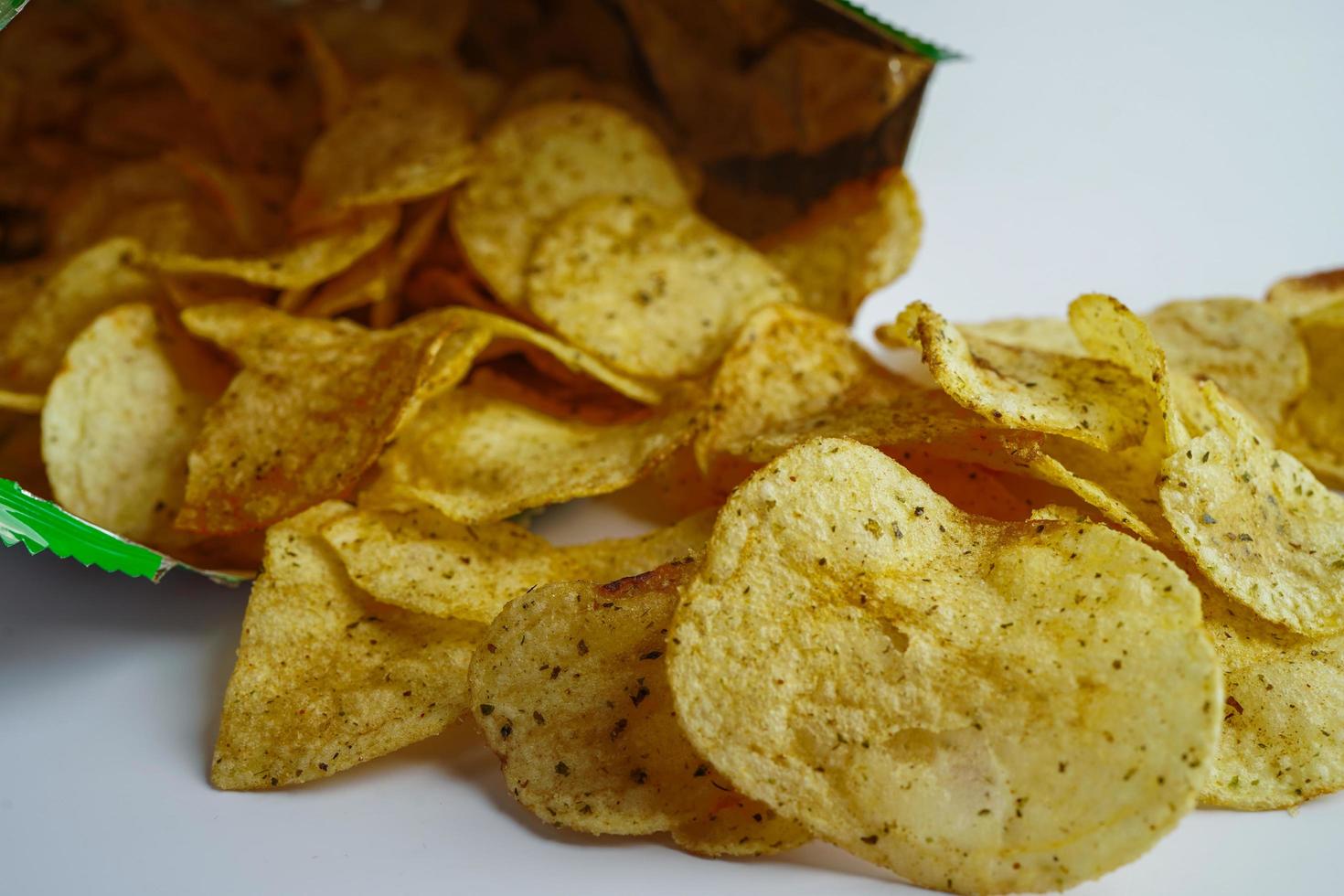 Potato chips in open bag, delicious BBQ seasoning spicy for crips, thin slice deep fried snack fast food in open bag. photo