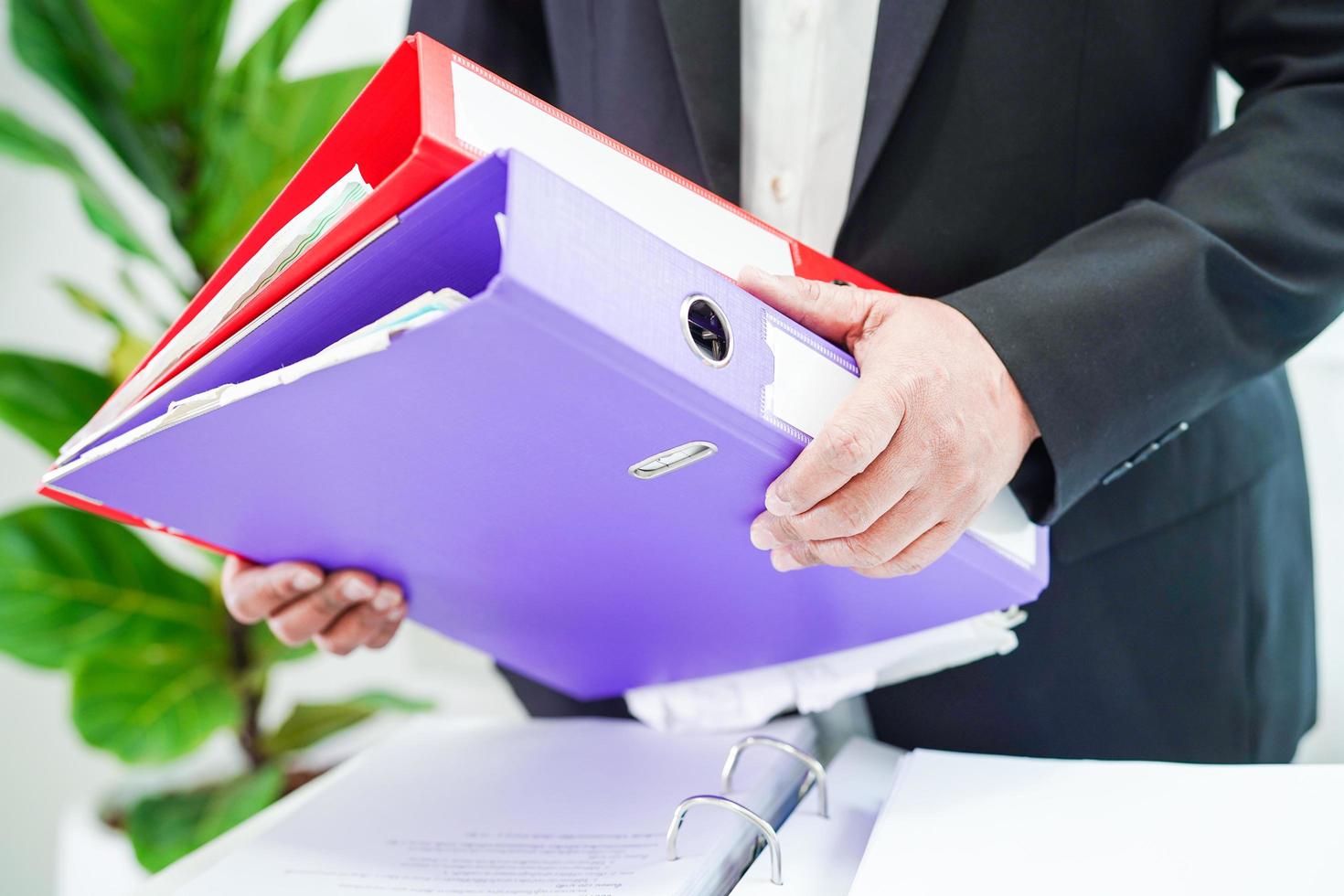 Businessman working and prepare paperwork report data to analysis information in file binder at office. photo