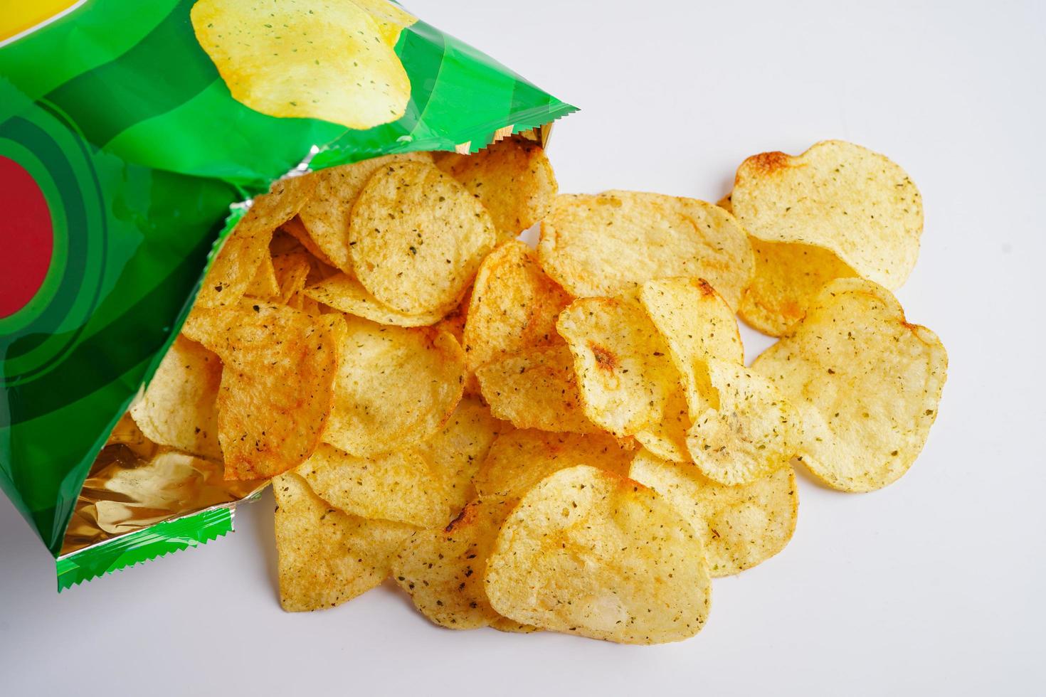 Potato chips in open bag, delicious BBQ seasoning spicy for crips, thin slice deep fried snack fast food in open bag. photo