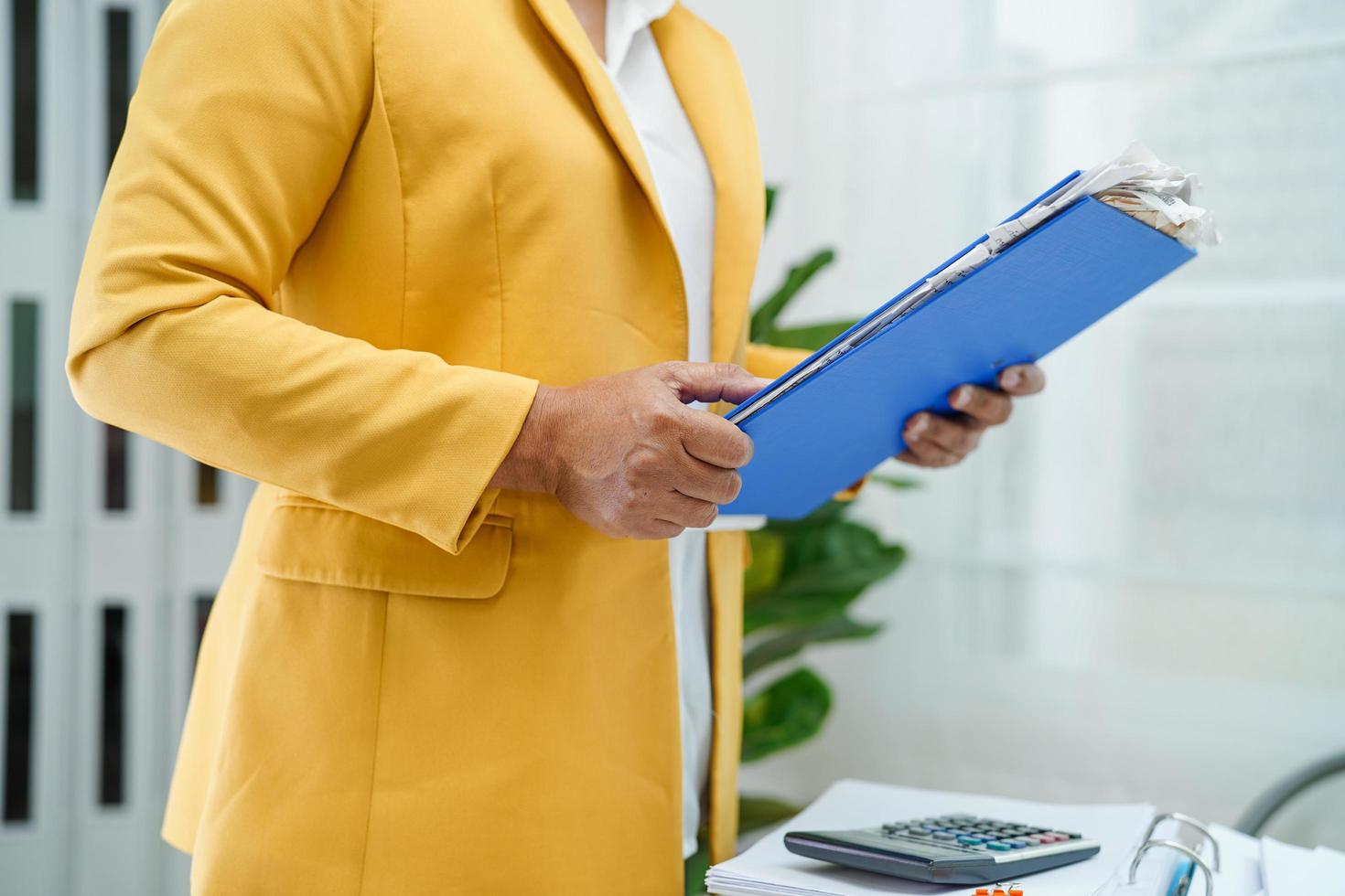 Businessman working and prepare paperwork report data to analysis information in file binder at office. photo