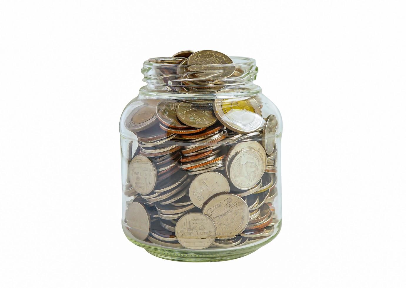 Money coins in grass jar isolated on white background with clipping path, Business saving banking finance investment concept. photo