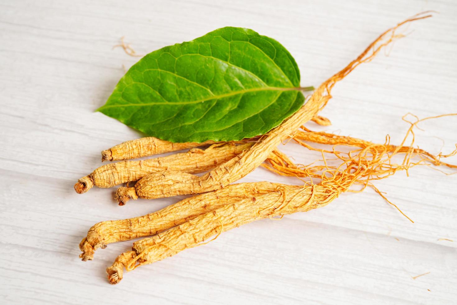Ginseng roots and green leaf, healthy food. photo