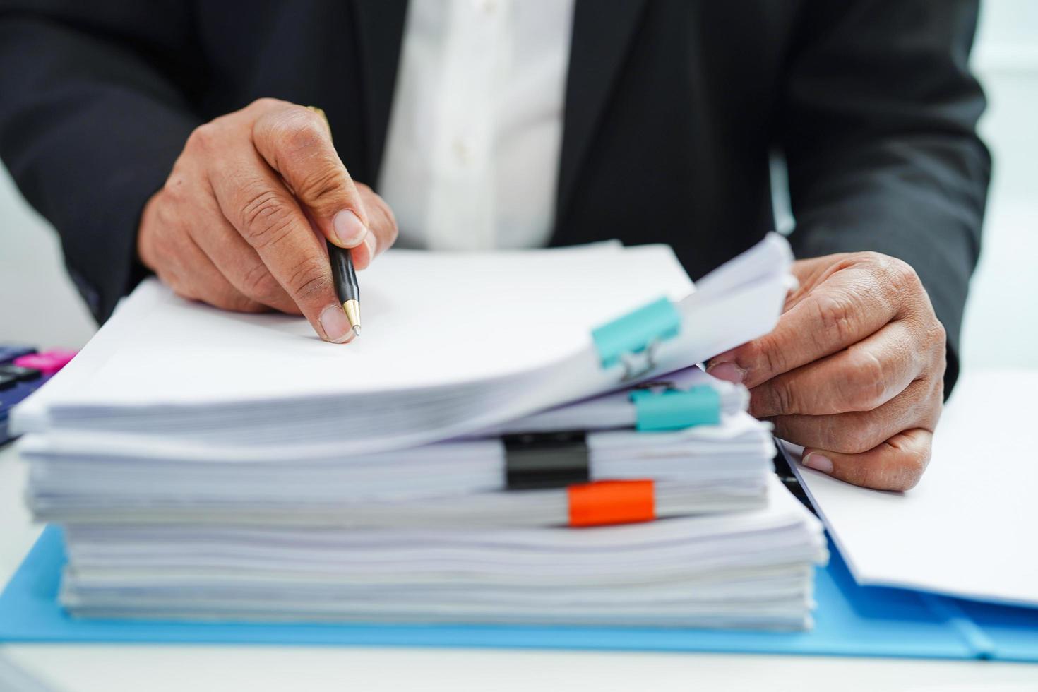 Businessman working and prepare paperwork report data to analysis information in file binder at office. photo