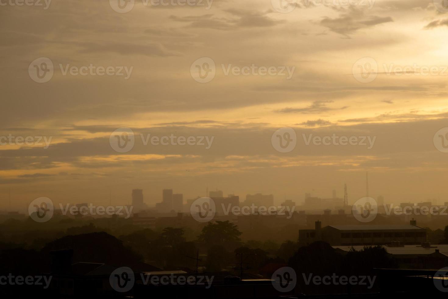 Background heavy rain falling from rainy season sky, tree and building silhouette, tropical Thailand. photo