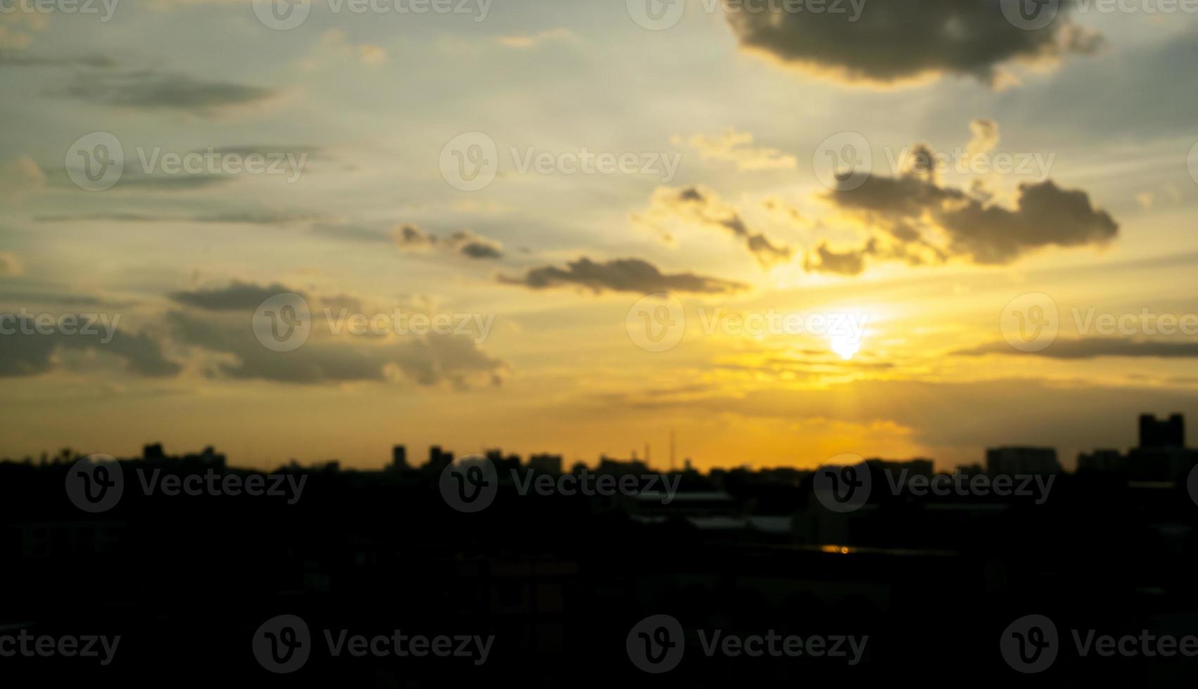 Gives a warm feeling,sunset behind the city building,silhouette city tall buildings,building silhouette again beautiful sky background and freedom concept. photo