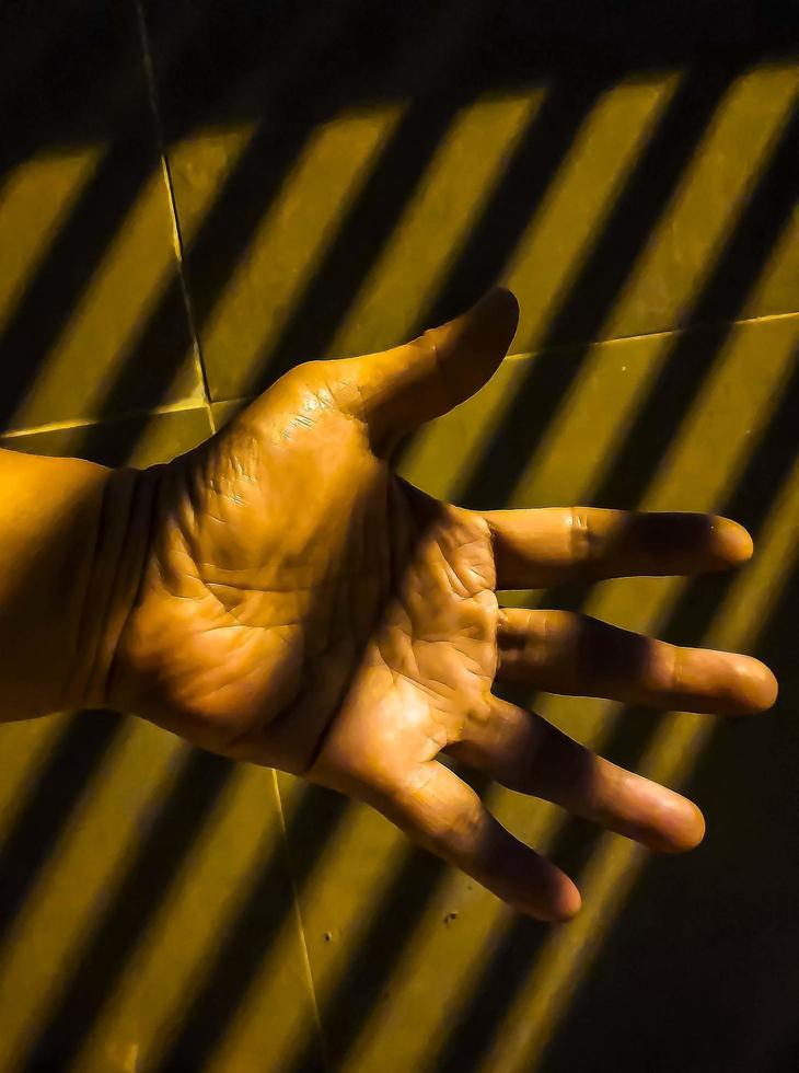 Contract stripes shadow on the hand palm photo