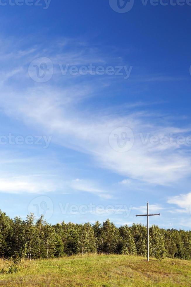 metal cross in the wood photo