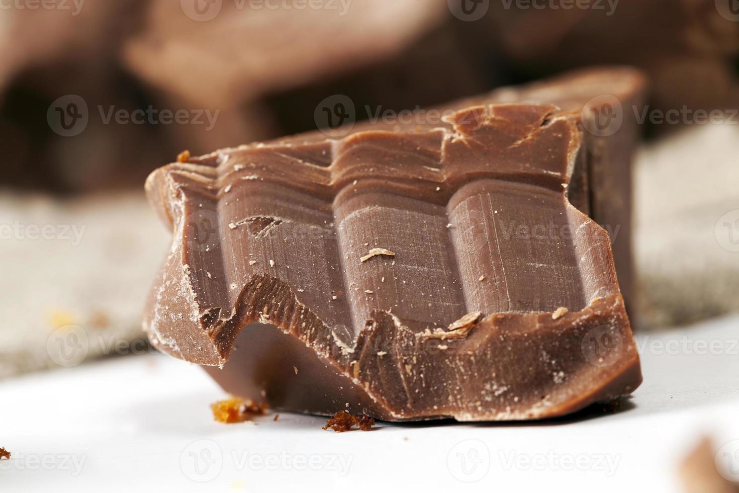 broken into several parts pieces of chocolate from cocoa photo