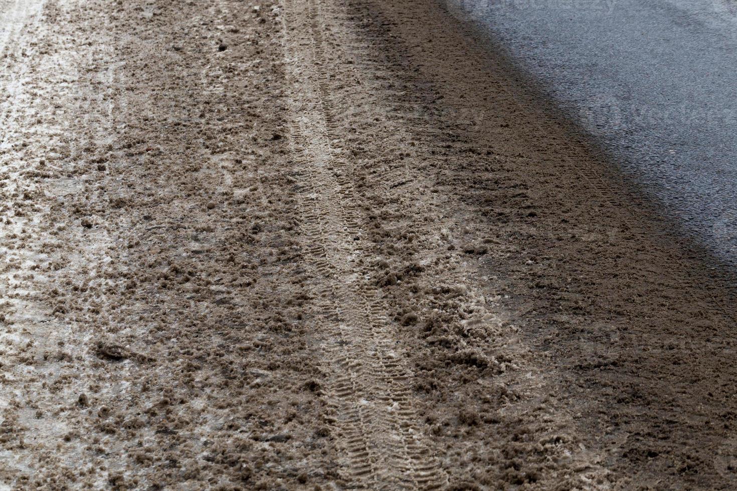Dirty snow on the road photo