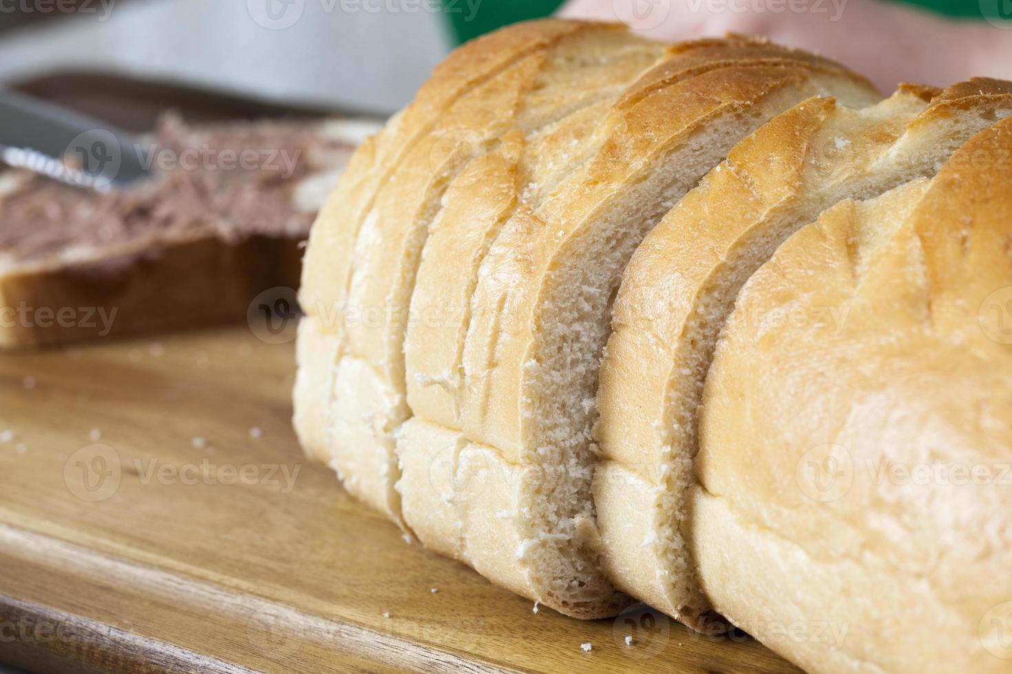 sliced white bread with smeared chocolate butter photo