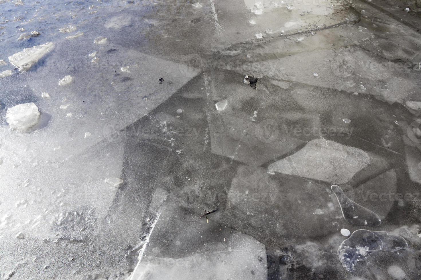 gray dirty ice on puddles photo