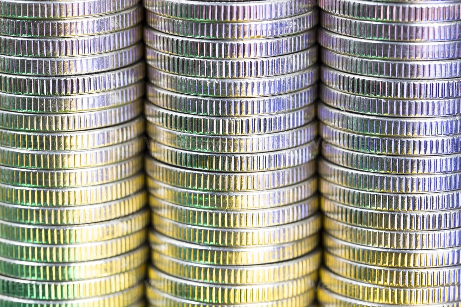 coins of silver color illuminated with yellow green color photo