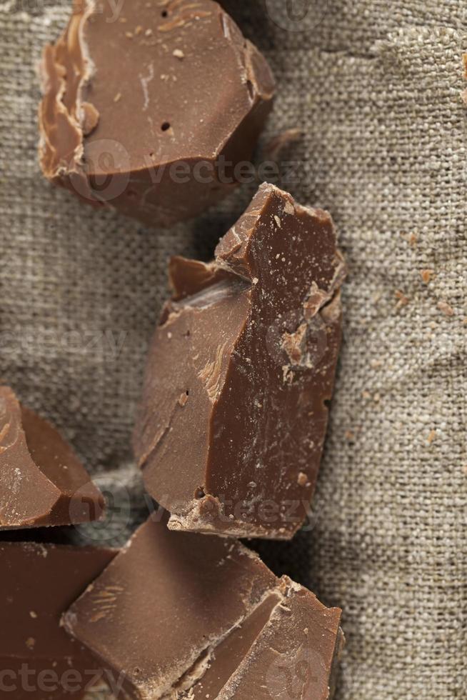 broken into several parts pieces of chocolate from cocoa photo