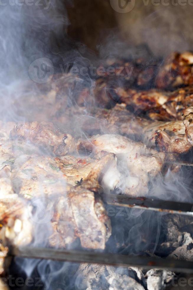 Cooking meat on the grill photo