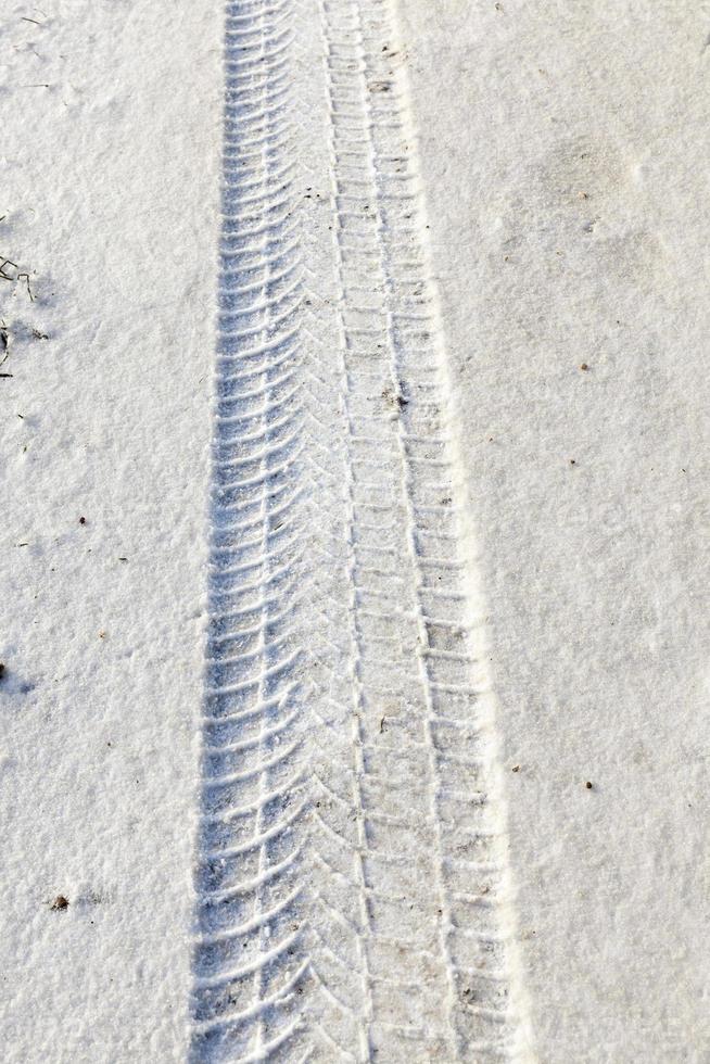fingerprint from the car tires on snow close up photo