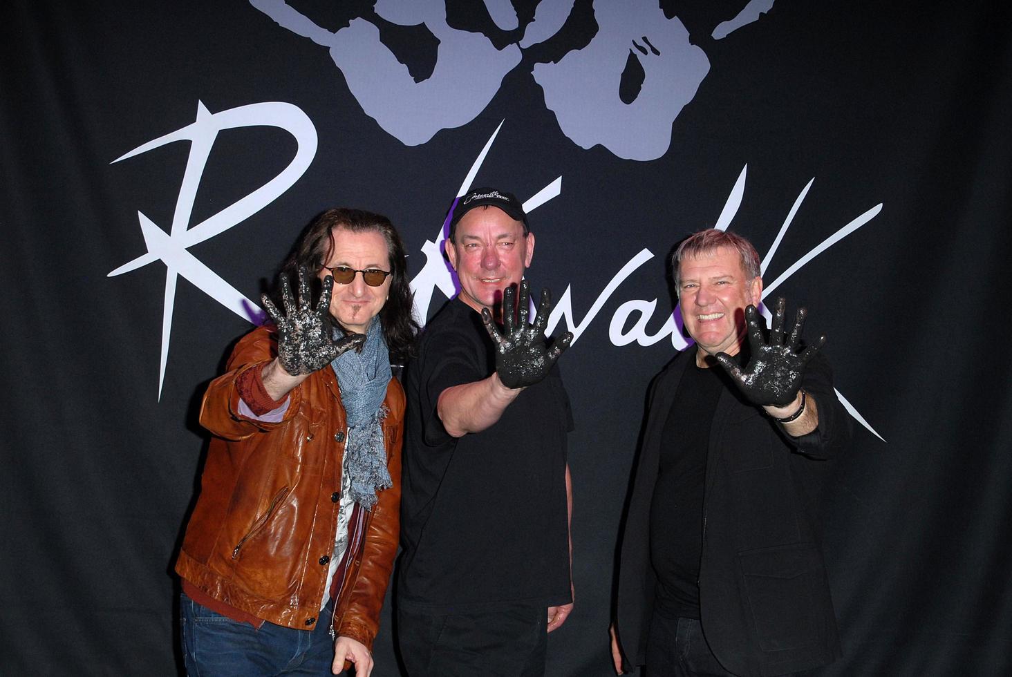 LOS ANGELES, NOV 20 - RUSH, Geddy Lee, Neil Peart, Alex Lifeson at the ceremony where RUSH is Inducted Into Guitar Center s RockWalk at Guitar Center on November 20, 2012 in Los Angeles, CA photo