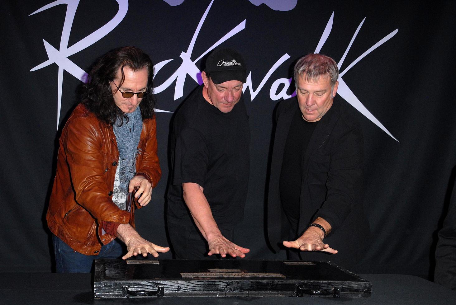 LOS ANGELES, NOV 20 - RUSH, Geddy Lee, Neil Peart, Alex Lifeson at the ceremony where RUSH is Inducted Into Guitar Center s RockWalk at Guitar Center on November 20, 2012 in Los Angeles, CA photo