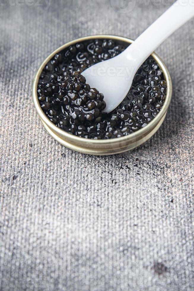 black caviar sturgeon fish beluga, stellate sturgeon fresh healthy meal food snack diet on the table copy space food background rustic top view photo