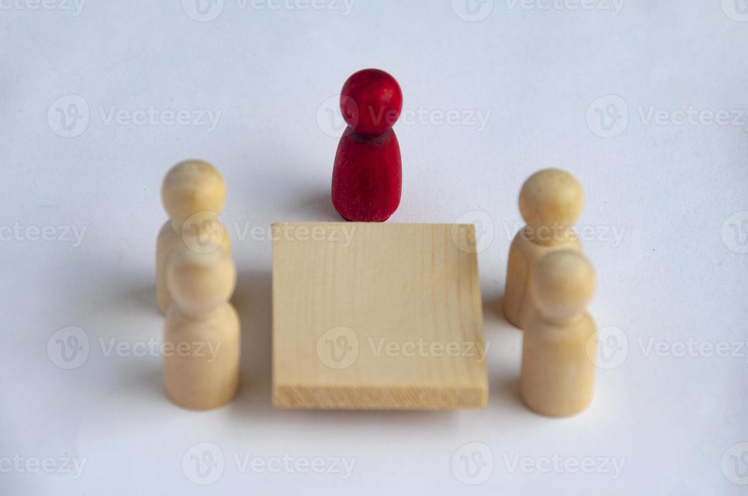 Wooden people figures having business meeting with customizable spare for text or ideas. photo