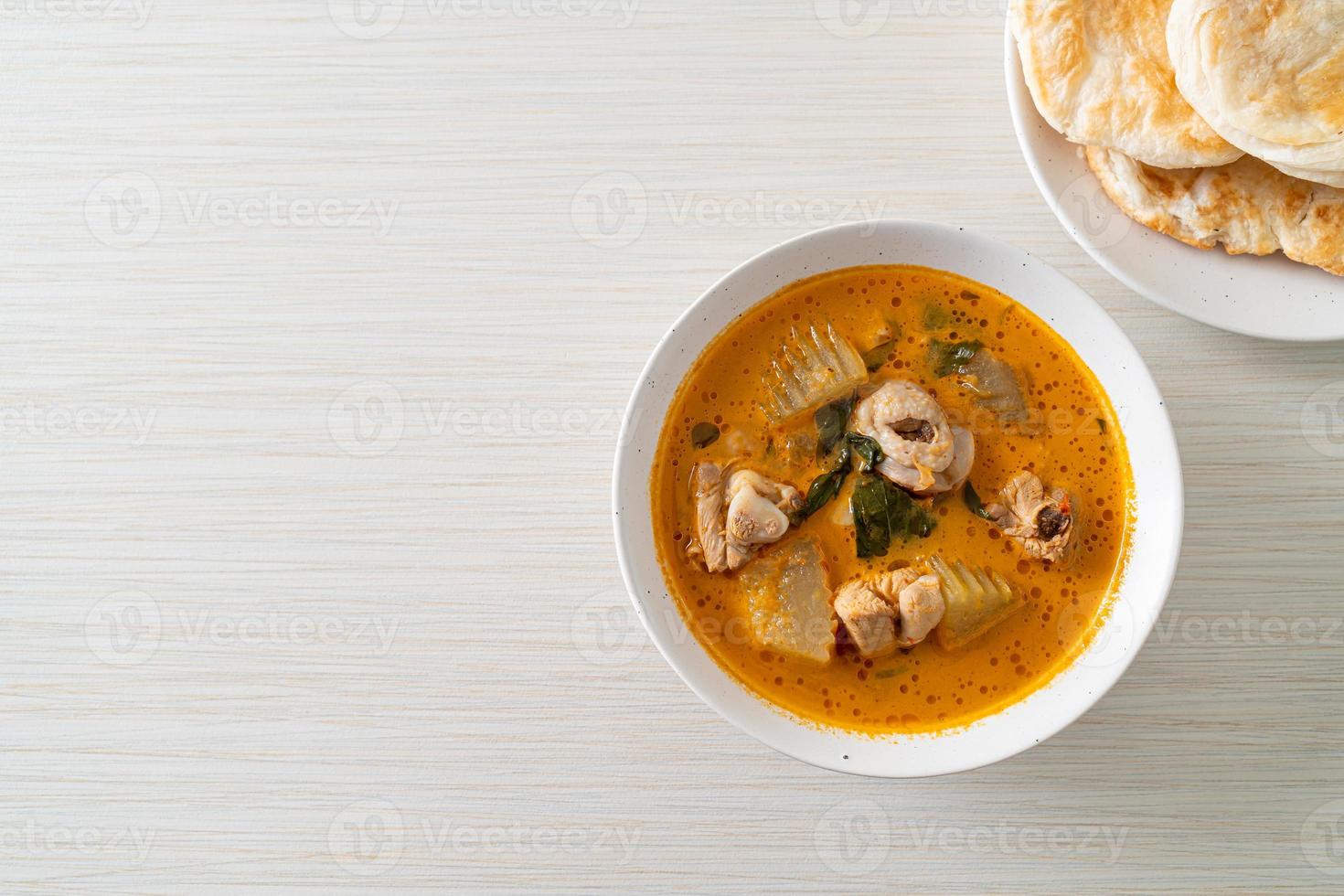 Chicken curry soup with roti photo