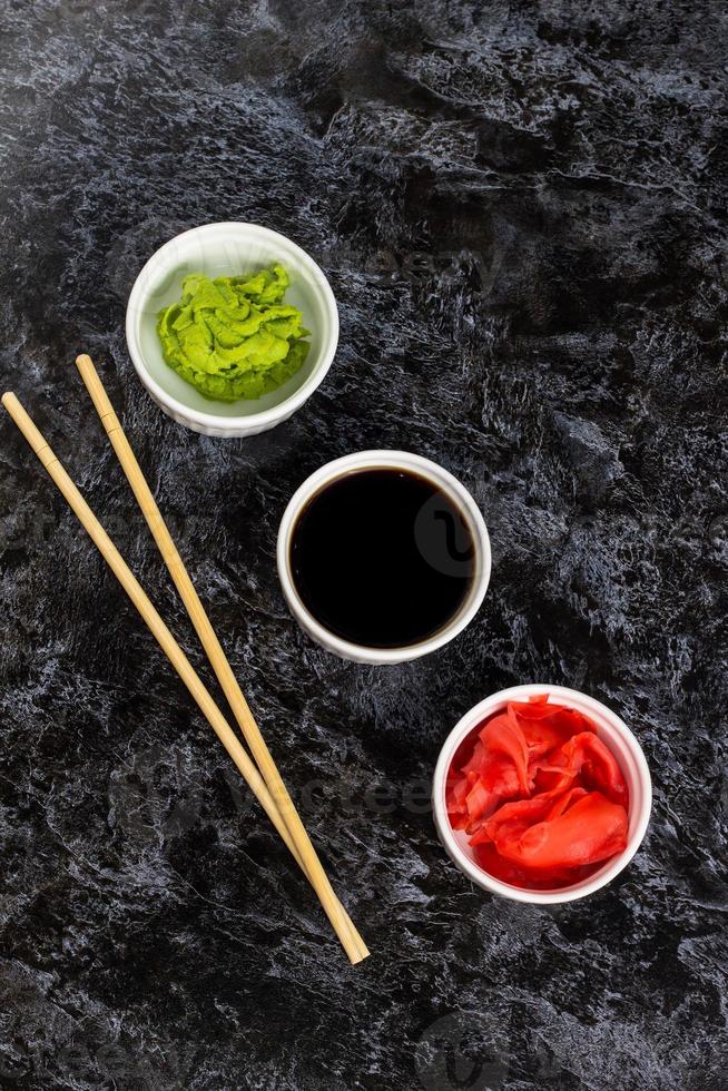 Set for sushi soy sauce ginger wasabi with chopstick on stone