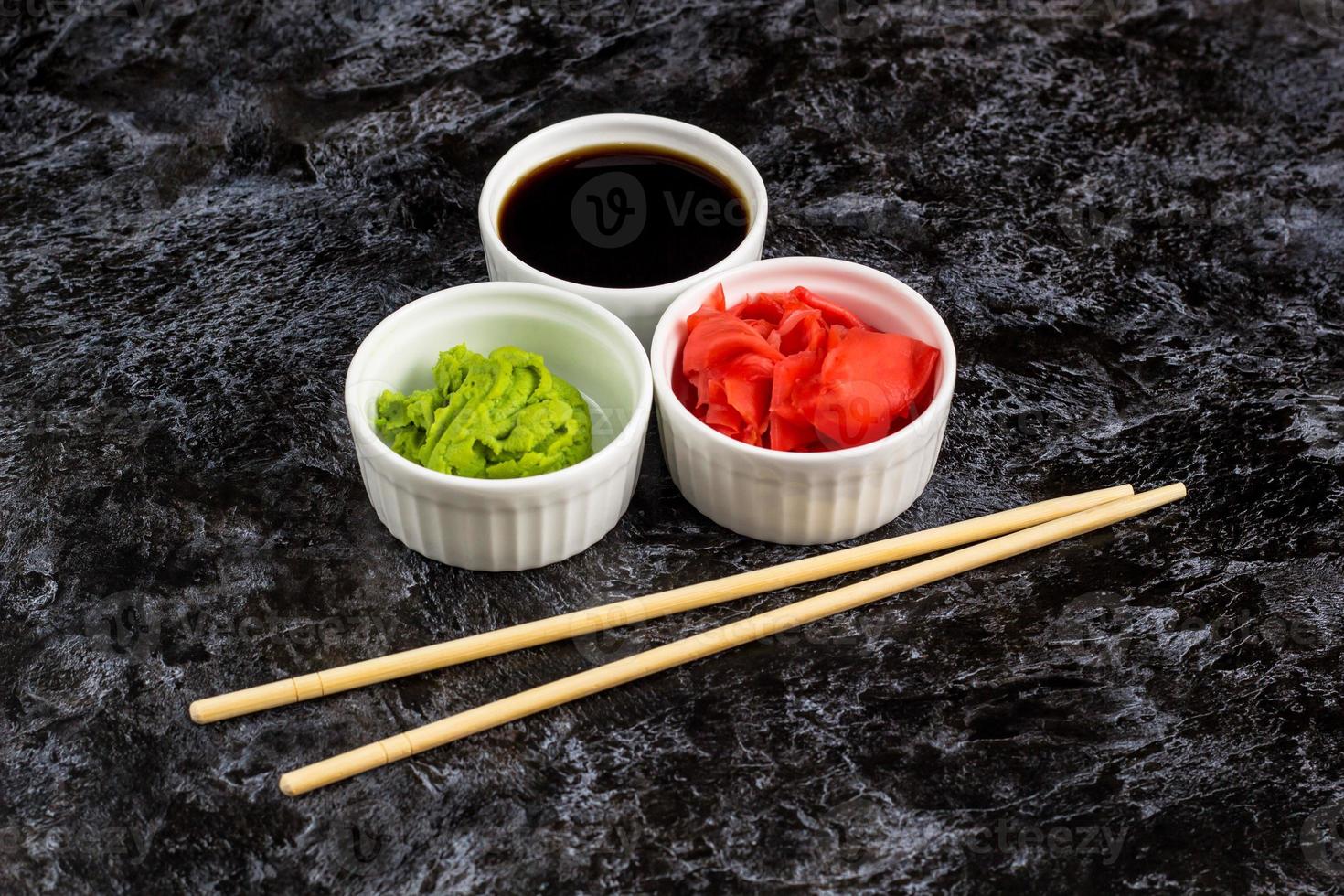 Set for sushi soy sauce ginger wasabi with chopstick on stone