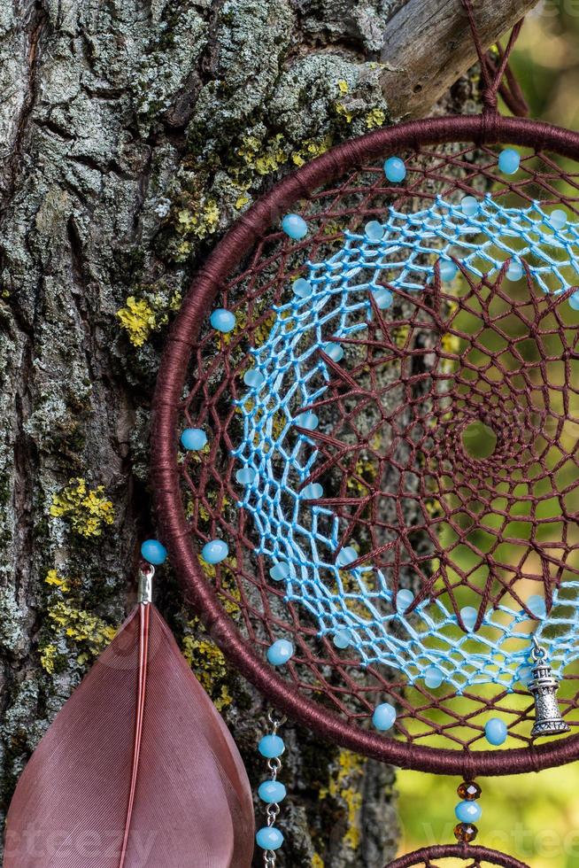Handmade dream catcher with feathers threads and beads rope hanging photo
