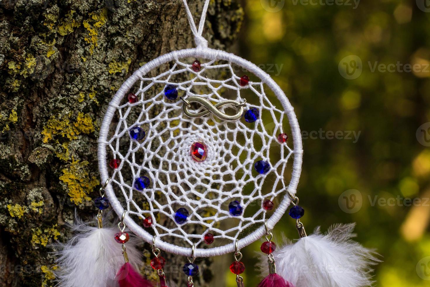 Handmade dream catcher with feathers threads and beads rope hanging photo