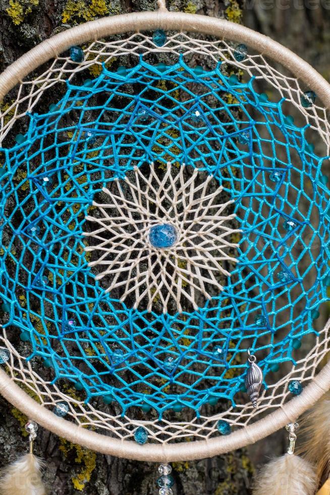 Handmade dream catcher with feathers threads and beads rope hanging photo