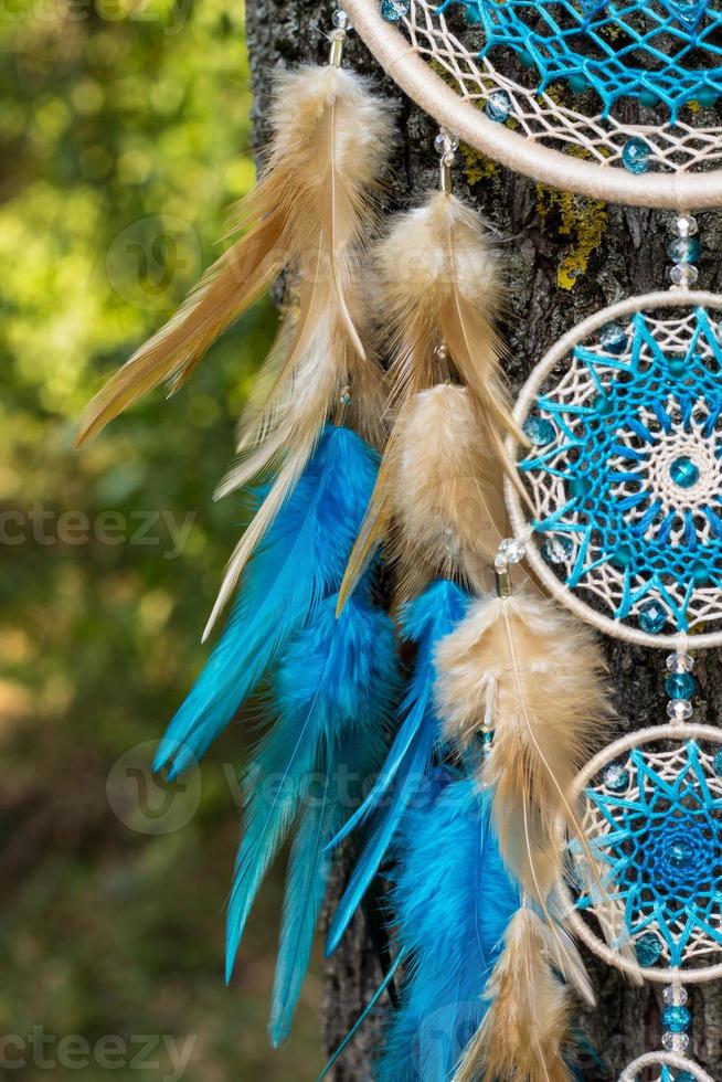 Handmade dream catcher with feathers threads and beads rope hanging photo