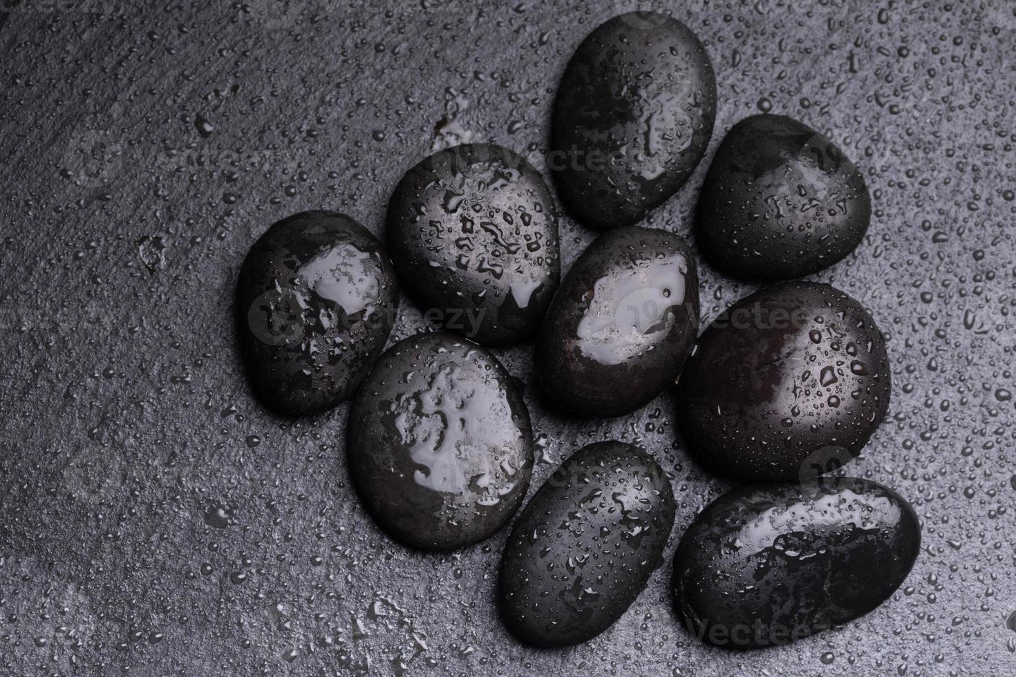 Black pebbles for texture for background stones or rocks and water drops. photo