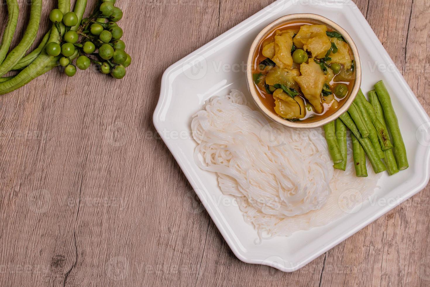 Rice noodles in fish curry sauce with vegetables photo