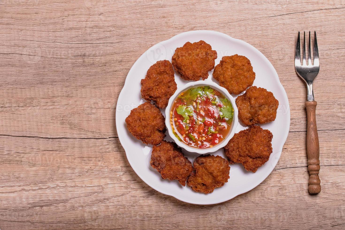 Fried Pork Cake with Ketchup and Chili Sauce on a white table top view. Asia Travel Cuisine concept. photo