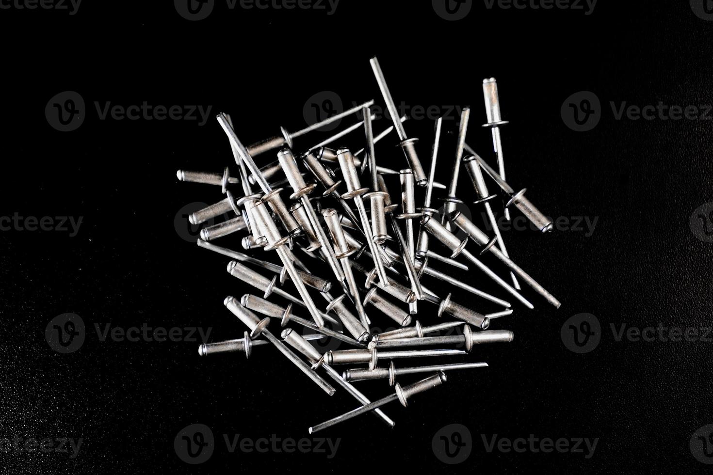 rivet nails on black background photo