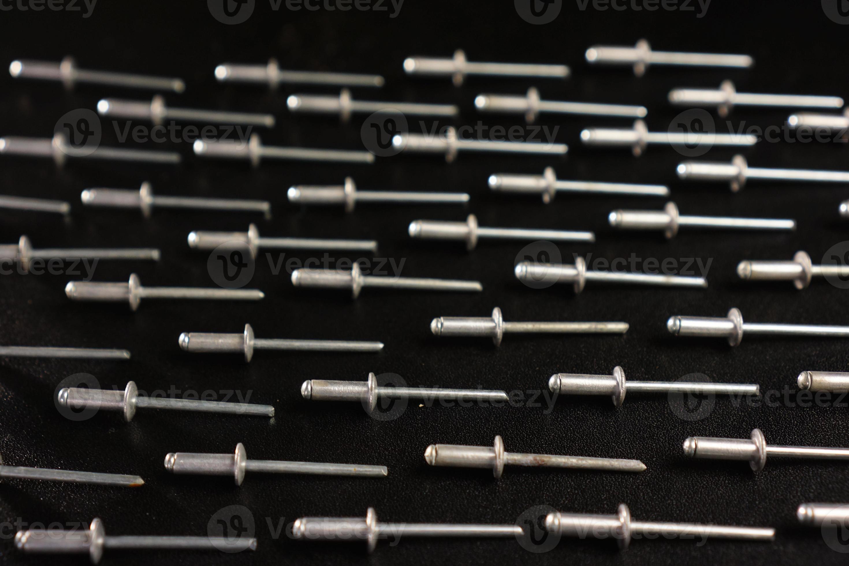 rivet nails on black background 9545126 Stock Photo at Vecteezy