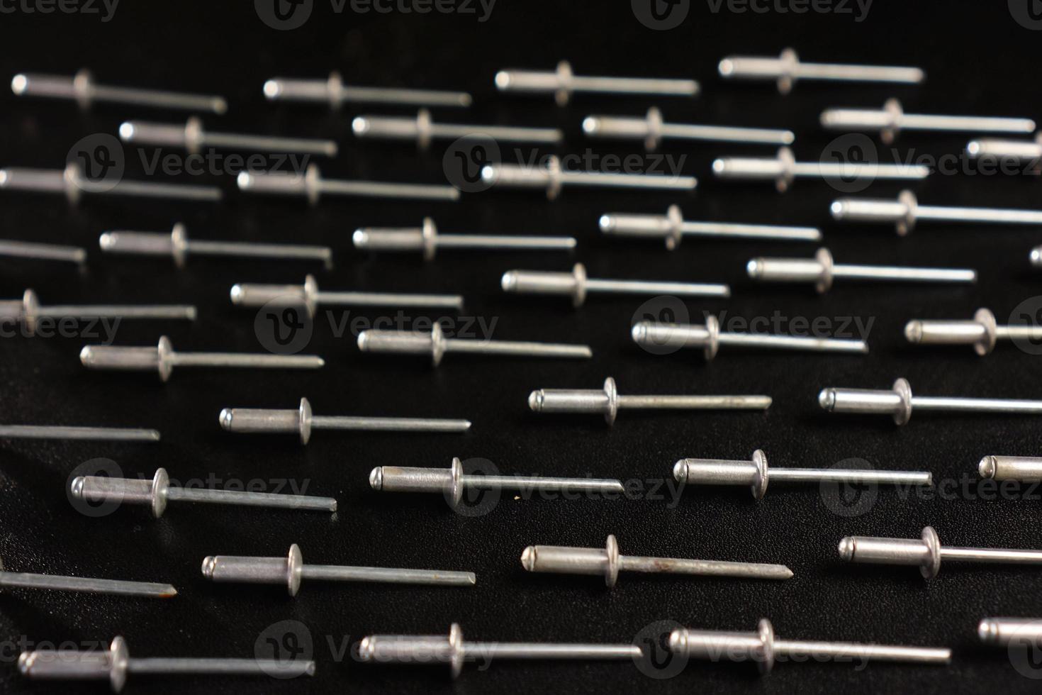 rivet nails on black background photo